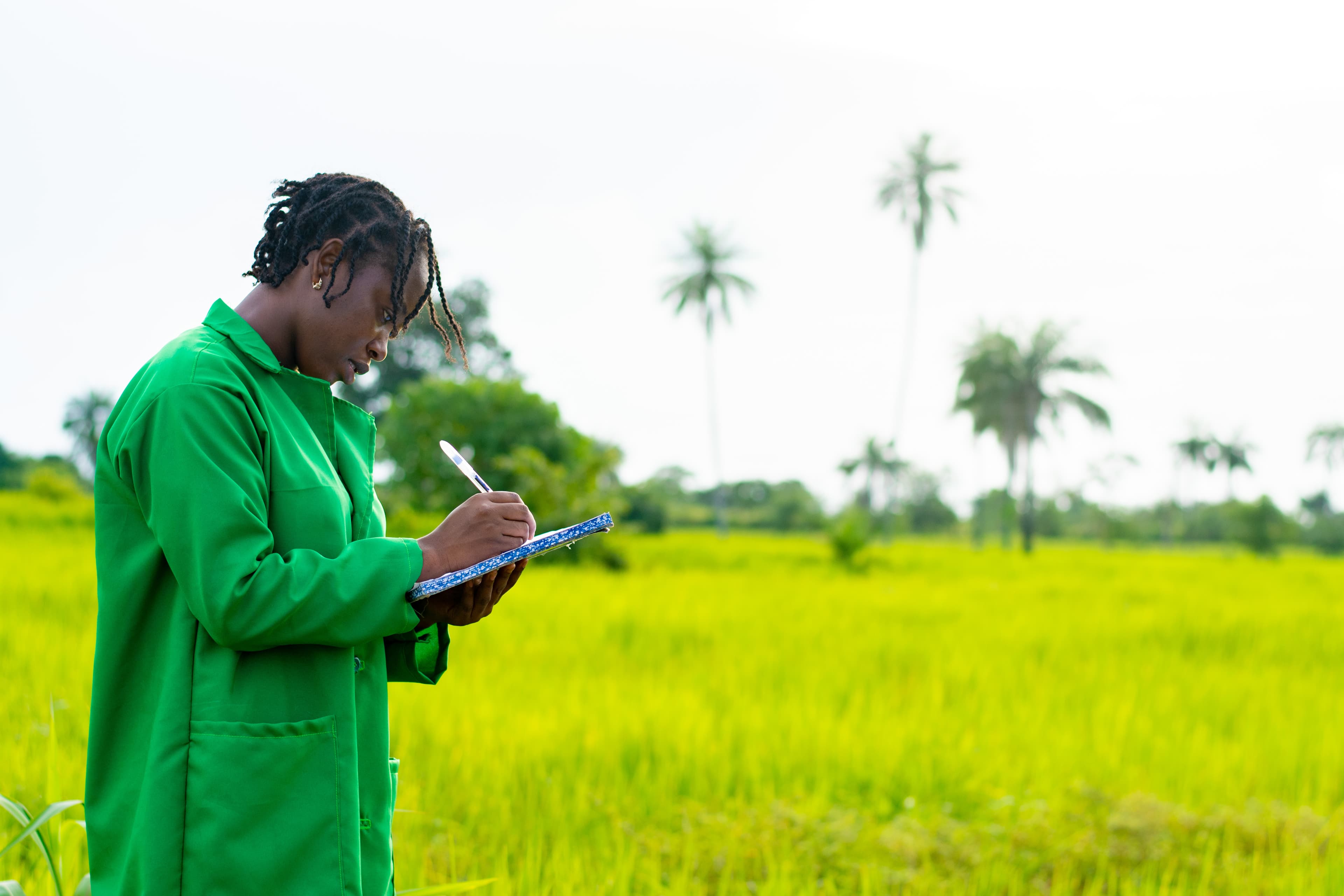 African farmer taking notes on farm